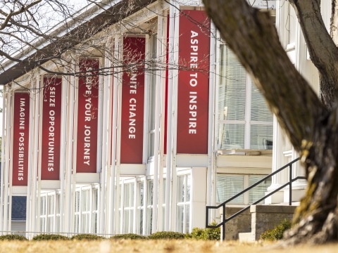 Exterior of the Center for Careers, Life, and Service building with red banners flying