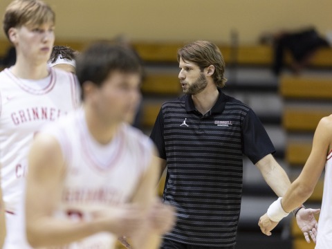 Jeff Smith giving players high fives on court