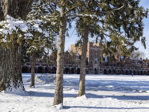 snow on ground and gates building in background
