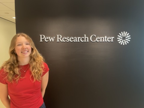 Skylar poses next to the Pew Research Center sign