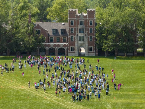 MtC Banner: Aerial view of incoming class of new students in front of Gates Hall