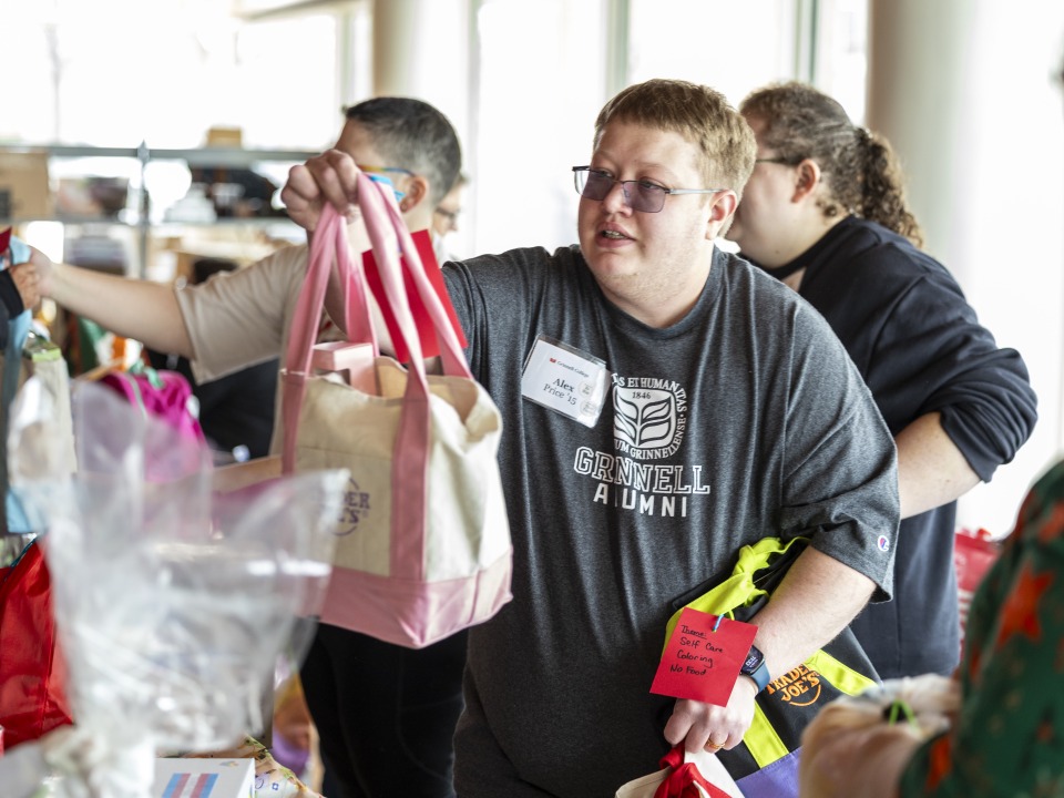 alumni holding a care package 