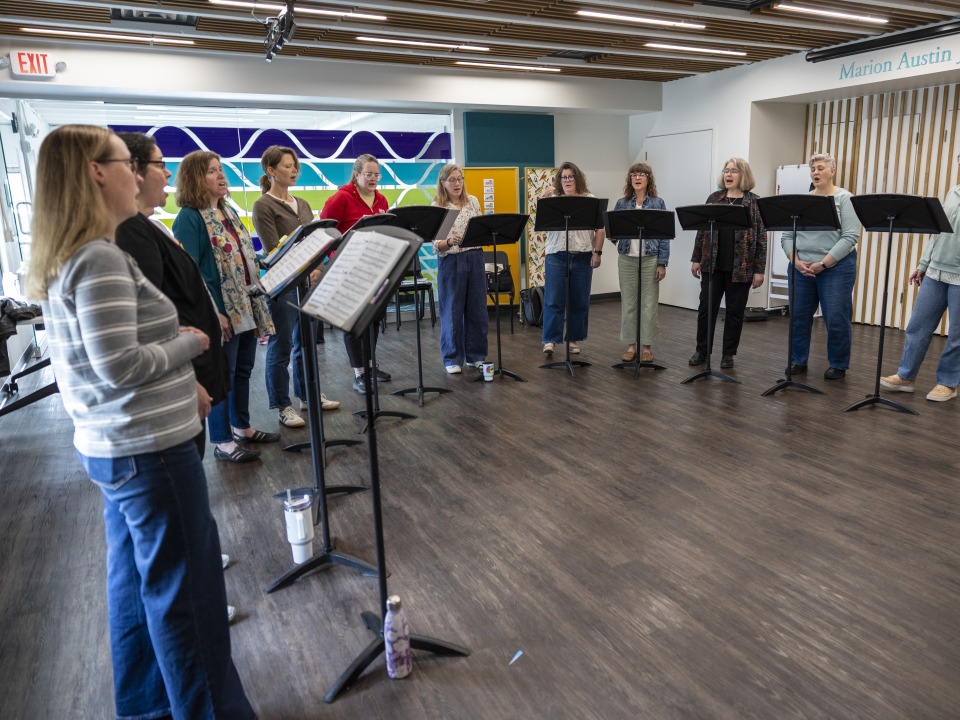Group of Women Singing in a circle 