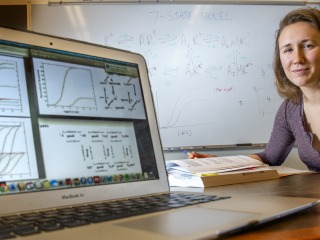 Josie Bircher next to computer with models of data