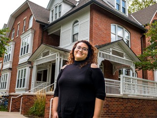 Lizeth Gutierrez ’12 in front of Mears Cottage