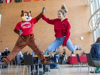 Student and squirrel mascot celebrating Give Back Day