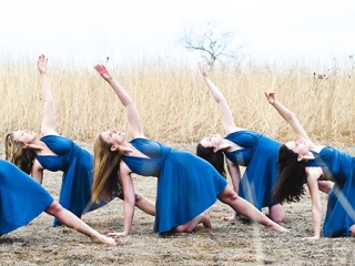 Dancers in blue dresses on the prairie