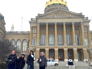 Four students in front of the Iowa State Capitol