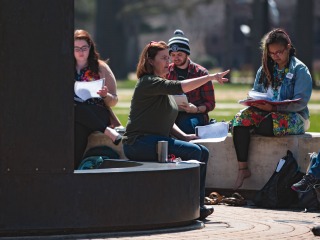 Students attend class outside.