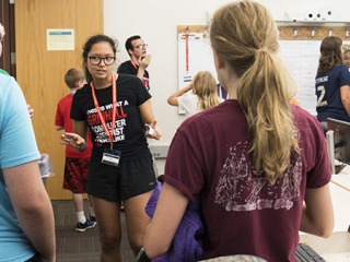 Code camp counselors talk with small groups of campers