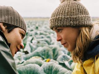 Still from Femde Haut of the main characters talking in a field