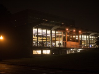 Burling Library at night, windows lit