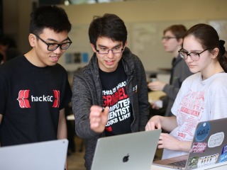Three students collaborate in HackGC 2019