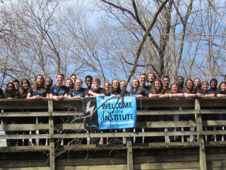All participants stand on a bridge together at Leadershape Retreat, 2017
