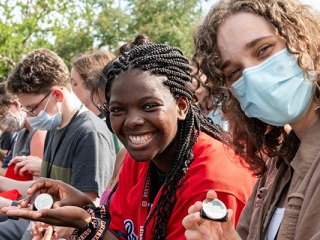 First-year students display the medallions they received at the class of 2025 welcome ceremony Friday.