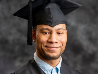 Max Hill in graduation robes