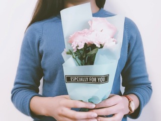 Woman holding bouquet that says Especially For You