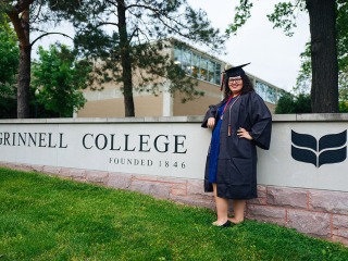Denisha Renovales stands by Grinnell College entrance