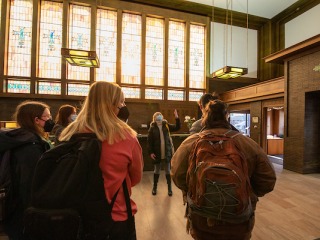 Art history students look at stained glass windows in Louis Sullivan's Merchants' Bank
