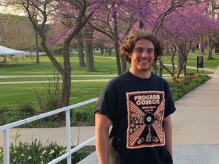 Finn Dworkin at Grinnell, redbud trees in bloom