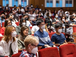 Students participating in the International Pre-Orientation Program sitting in an auditorium
