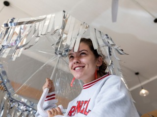 Student holding umbrella with silver tassels 