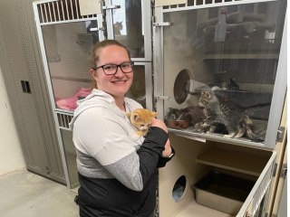 volunteer holding cat at PALS