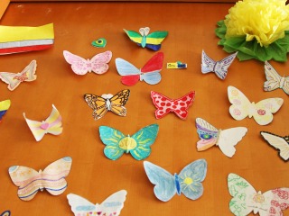 A door with many taped butterflies, mini-flags and paper flowers as decoration