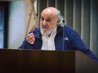 Harold Kasimow speaks at a podium