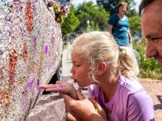 girl blowing glitter on truck