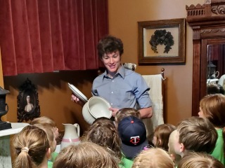 Evan Albaugh '25 leads a group of students on a tour of Hoyt Sherman Place in Des Moines.