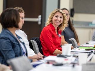 Woman in red shirt engaged in conversation 