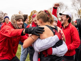 2 people hugging after cross country race