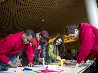 Four students of color make Valentines Day cards