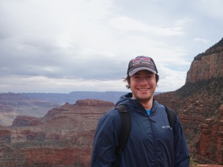 Ben Brim smiles with the Grand Canyon behind him