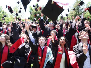 students tossing their hats at the 2024 Commencement Ceremony