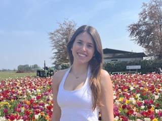 I stand near the blooming tulip flowers.