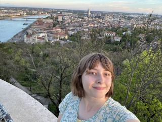 Nina Bigelow takes a selfie with the green mountain in back.