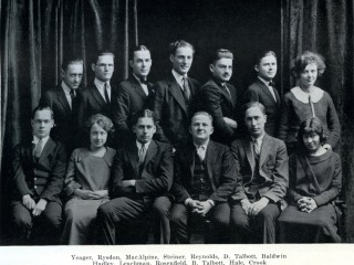 A black and white vintage photo of about a dozen young men and women in two rows
