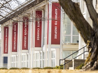 Exterior of the Center for Careers, Life, and Service building with red banners flying