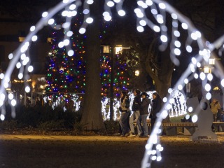Christmas lights and people walking
