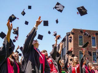 graduates throwing hats in the air 