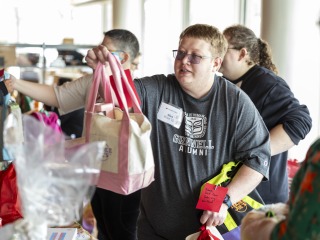 alumni holding a care package 