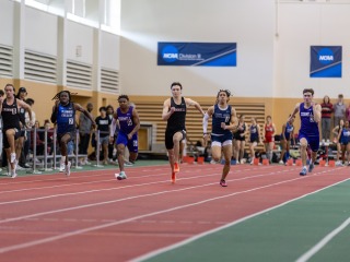 Lucas Fadden running during a meet in the Grinnell College Field House