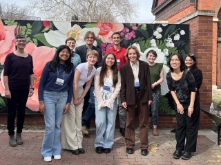 People standing in front of flower background 