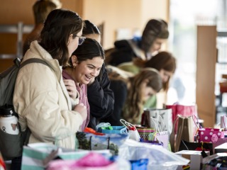 Happy students pick out a care packages sent by Grinnellians