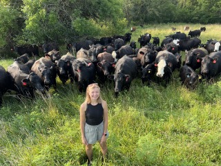 student with cows in the background