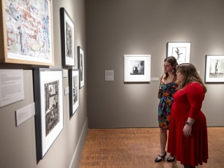 two students looking at art 