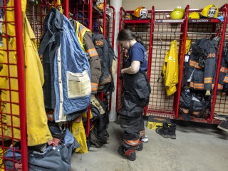 girl putting on fire suit