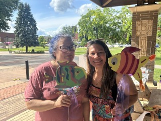 two women holding puppets 